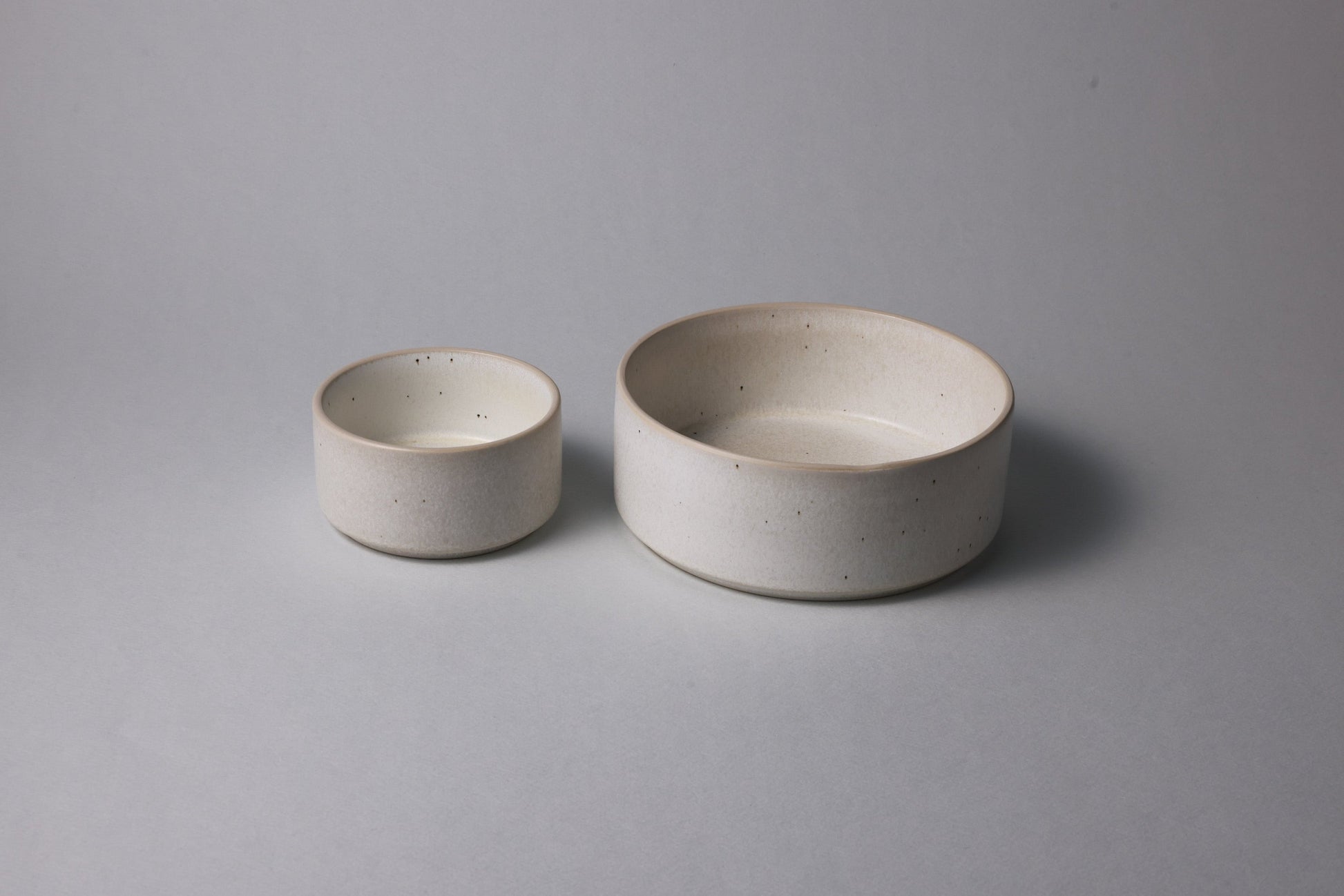 Two stoneware bowls with matte finish, warm white