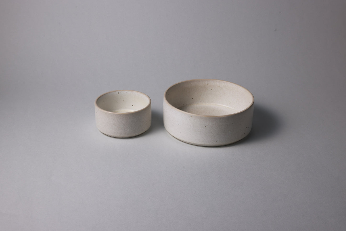 Two stoneware bowls with matte finish, warm beige