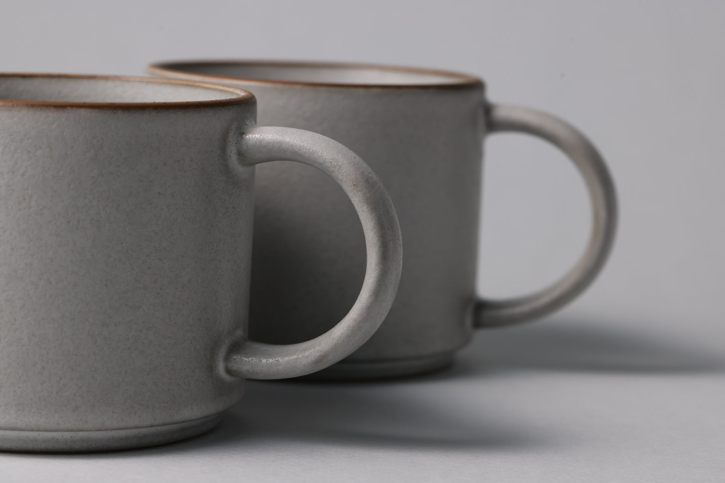 Two stoneware mugs with matte finish in soft gray