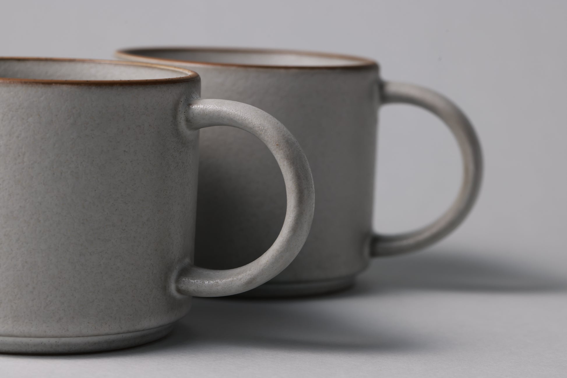 Two stoneware mugs with matte finish in soft gray