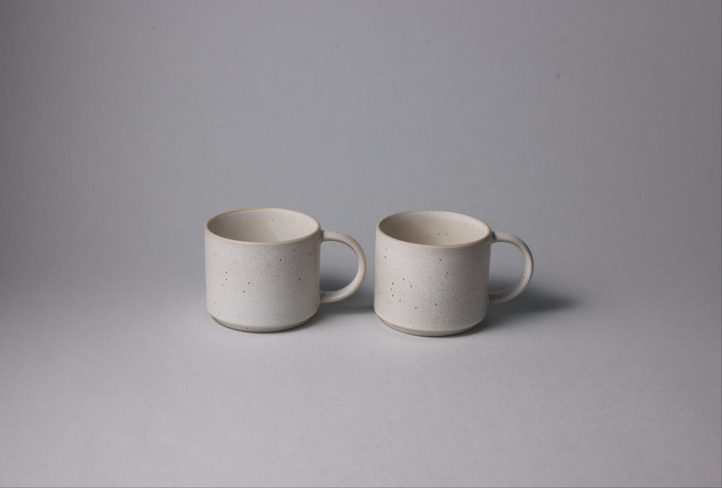 Two stoneware mugs with matte finish in soft beige