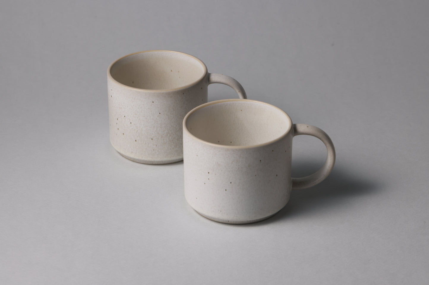 Two stoneware mugs with matte finish in soft beige