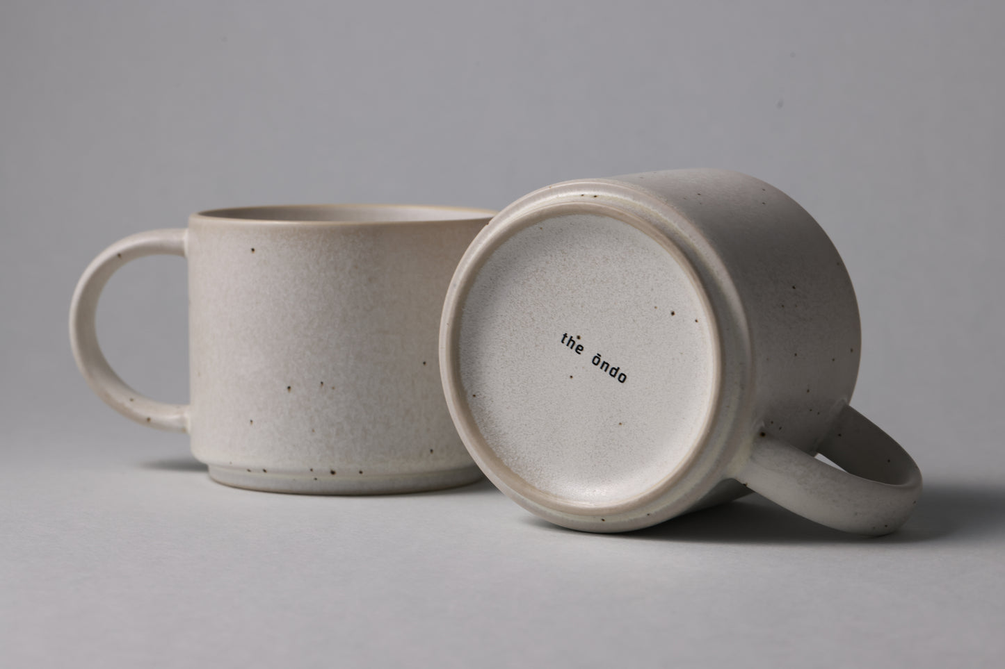 Two stoneware mugs with matte finish in soft beige