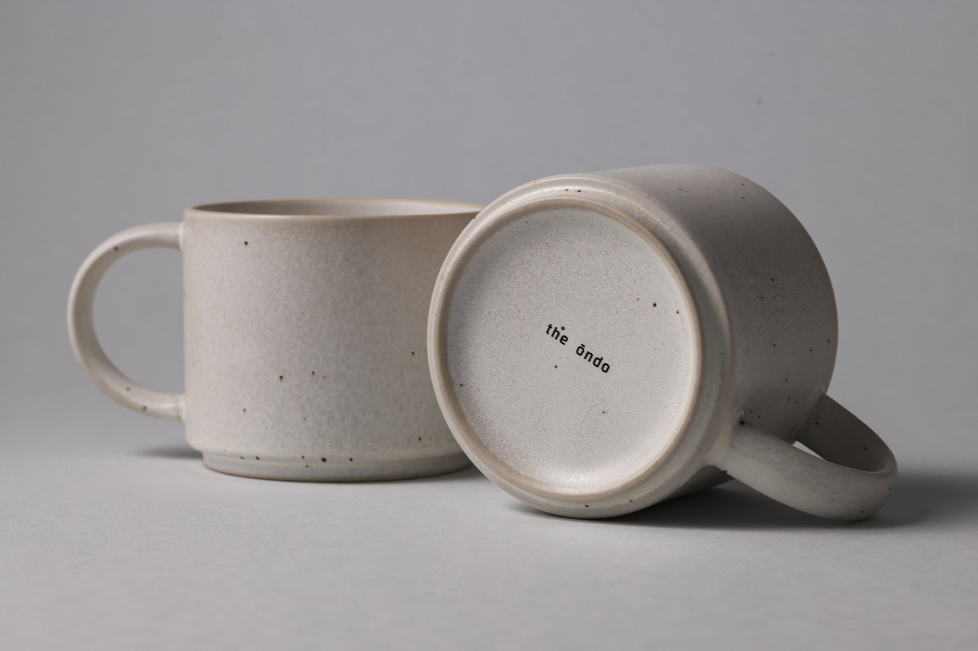 Two stoneware mugs with matte finish in soft beige