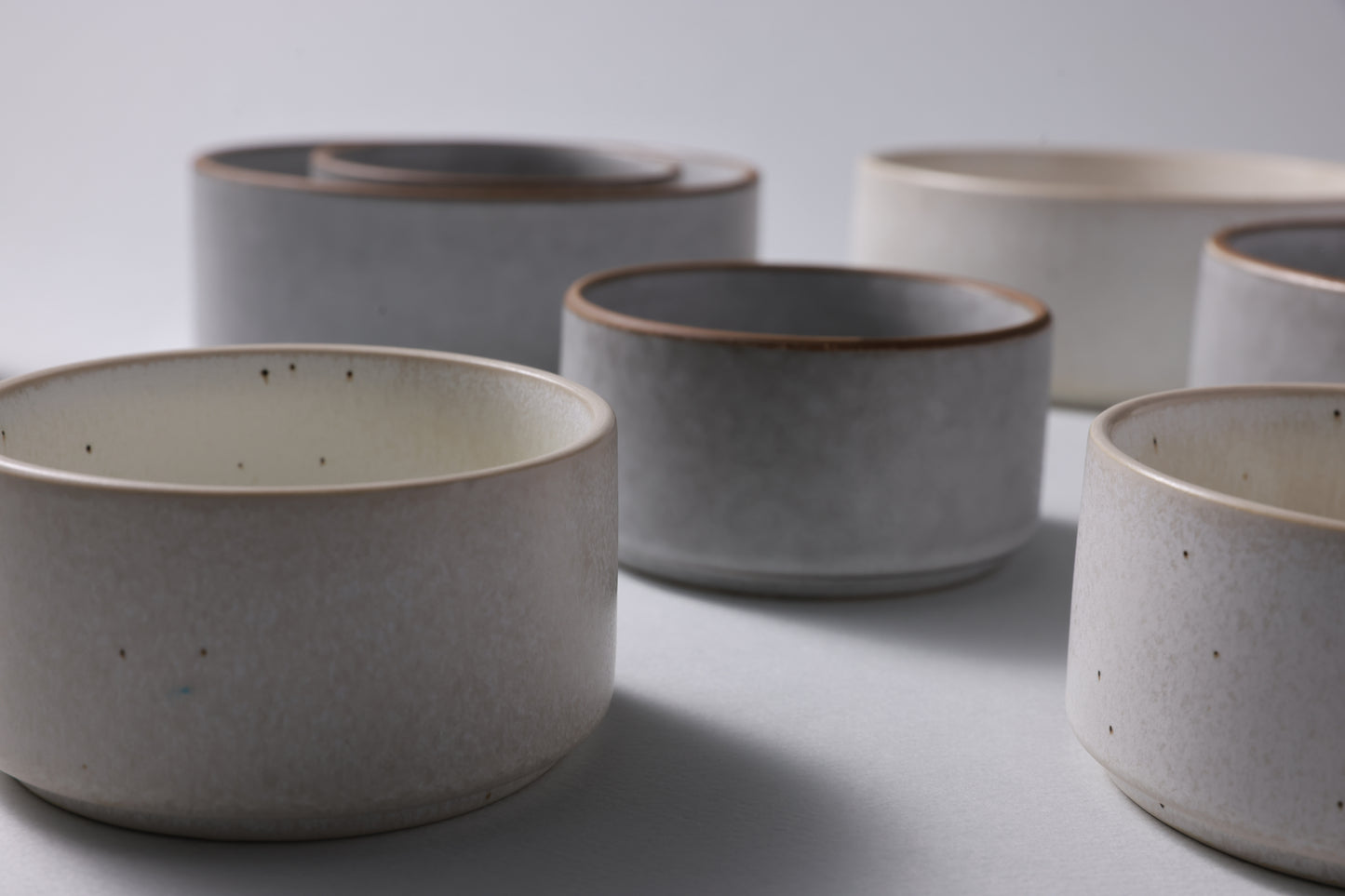 Two sizes of matte stoneware bowls shown together, highlighting scale and quiet form