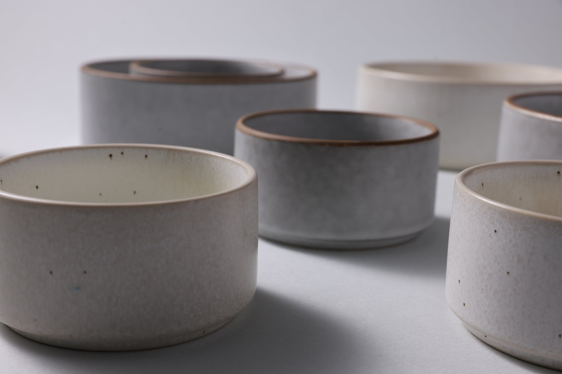 Two sizes of matte stoneware bowls shown together, highlighting scale and quiet form